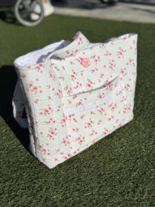 custom handmade children's outfits, embroidered accessories, diaper bags, and personalized gifts for families.