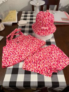 custom handmade children's outfits, embroidered accessories, diaper bags, and personalized gifts for families.