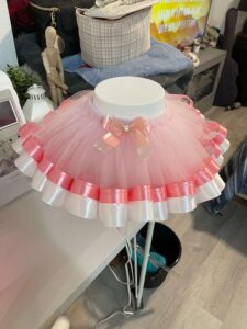 custom handmade children's outfits, embroidered accessories, diaper bags, and personalized gifts for families.