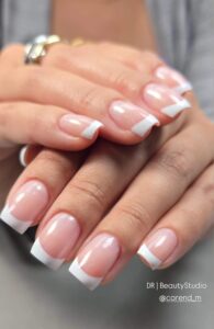 Classic French manicure with a soft pink base and crisp white square tips by DR Beauty Studio.